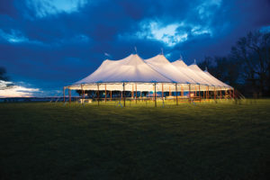 The translucent fabric of Anchor’s Aurora sheer-top tent combines with dramatic up-lighting for an appealing glow to nighttime events. Photo courtesy of Bailey’s Party Rentals, Leonardtown, Md., and Anchor Industries.