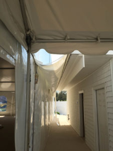 A chain is only as strong as its weakest link, and a connected tent is only as weatherproof as its leakiest seam. Custom gutters can be made of waterproof fabric and movable plastic channels that divert water away from the connecting points and entryways of tents. Photo: Chase Canopy Co.