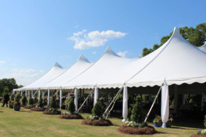 For a spring wedding in Shreveport, La., Macon Tent Rentals installed this 60-by- 120-foot white Century® tent with center and side pole drapes. Photo courtesy of Macon Tent Rentals. 