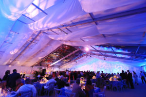For a wedding ceremony and reception in Cleveland, Ohio, All Occasions Event Rental provided an 82-by-165-foot clearspan tent that was separated by an interior gable draped with custom panels. Photo courtesy of All Occasions Event Rental.