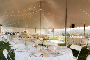 Basic inventory such as 60-inch rounds, strings of café lighting and white chairs remain extremely popular, as do softer colors and other classic decor touches. Photo courtesy of Tents for Rent LLC.
