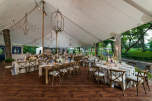 Sailcloth tents with 10-foot wood side poles and wood-grain center poles enhanced the natural beauty of a lakeside home for a wedding on Lake Geneva, Wis. Photo by Kent Drake Photography.