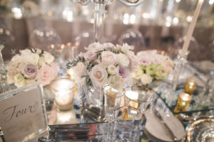 Gold and ivory decor, complemented by rose centerpieces, contribute to the romantic look of this wedding at the One & Only Ocean Club on Paradise Island in the Bahamas. Event planner: Wildflowers Events & Occasions. Photo by Philip Siciliano Photography.
