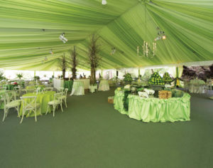 For this wedding, an 18-by-30-meter HTS-USA/Hocker Clearspan structure was installed on a BilJax® TF2100 engineered tent floor system for the dinner tent, overlooking the clear tents used for the dance area (see page 40). The client had a custom liner installed. Photo by Patterson Photography.