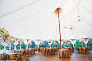 A sailcloth tent paired with wooden poles and flooring achieves the natural look today’s brides and grooms want. Wedding coordinator: Clearly Classy Events. Photo by Sherry Hammonds Photography.
